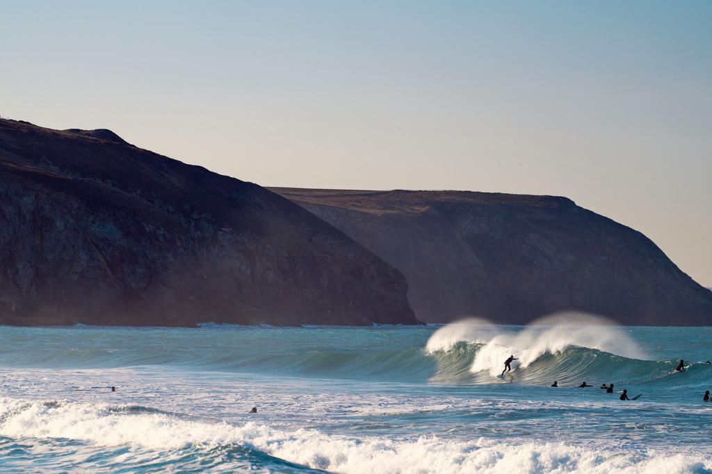 Surfer making a bottom turn at Porthtowan, Cornwall