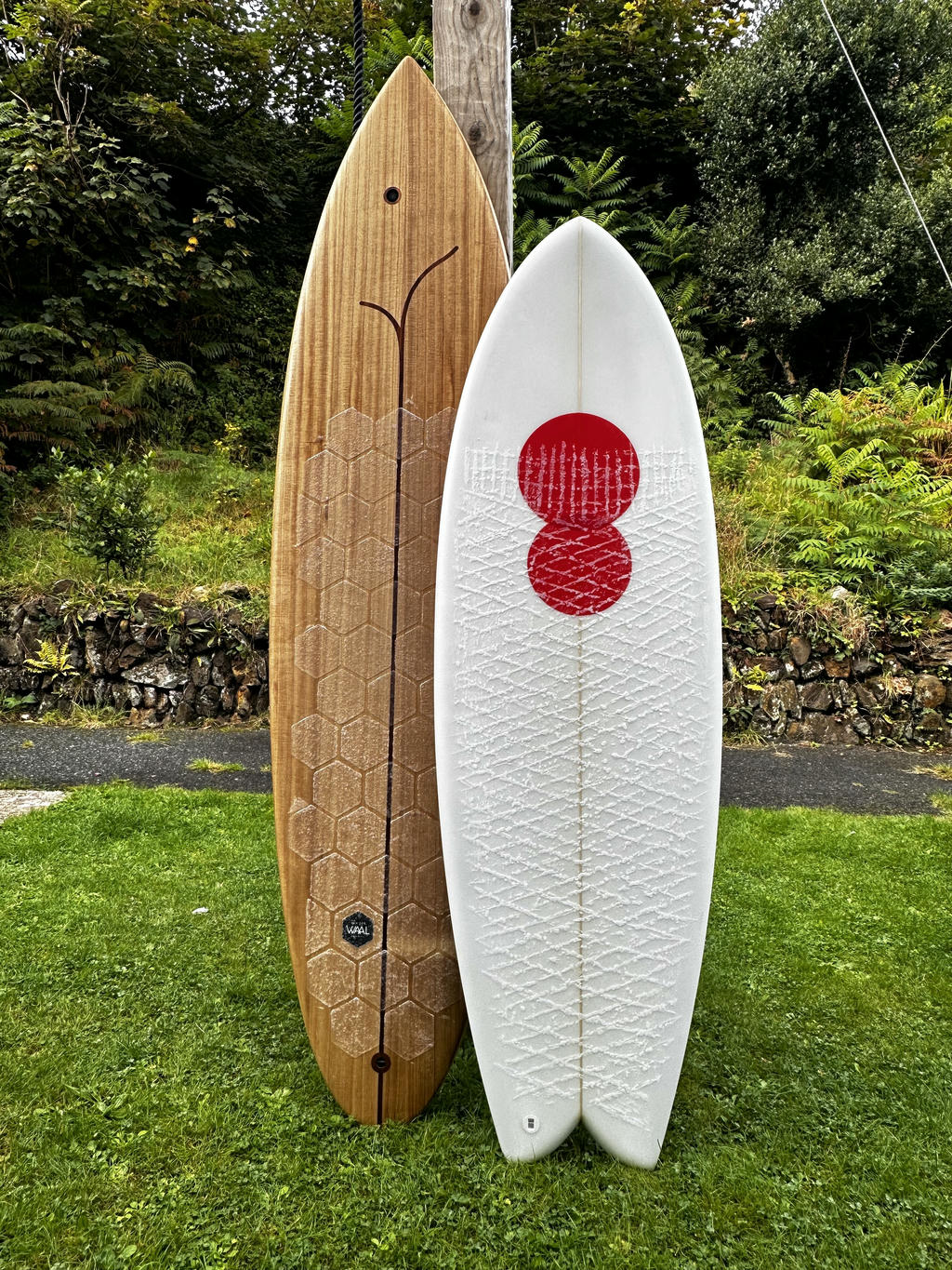 Two surfboards. Wooden Bosint Flagship and Cooper Electric Twin