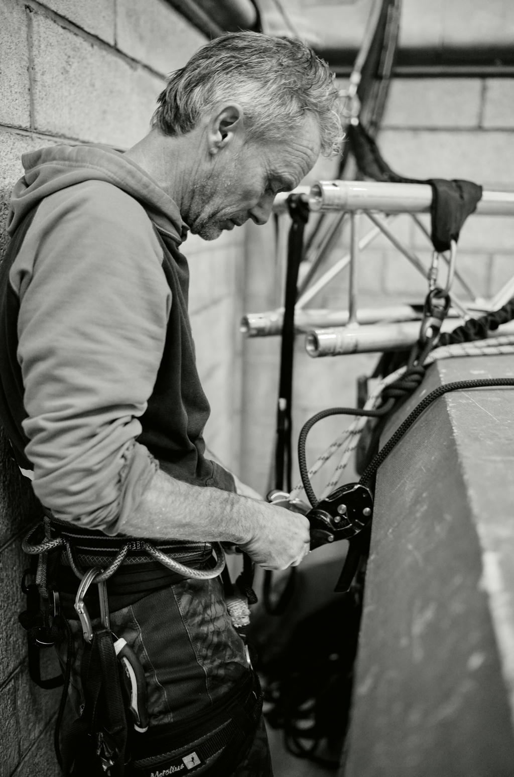 David Greeves from Yskynna Vertical Dance Company checking harness in Truro Cathedral